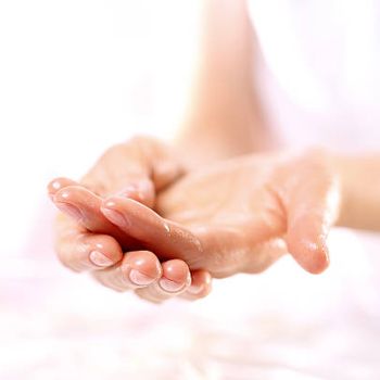 The woman assumes cotton gloves after applying wax